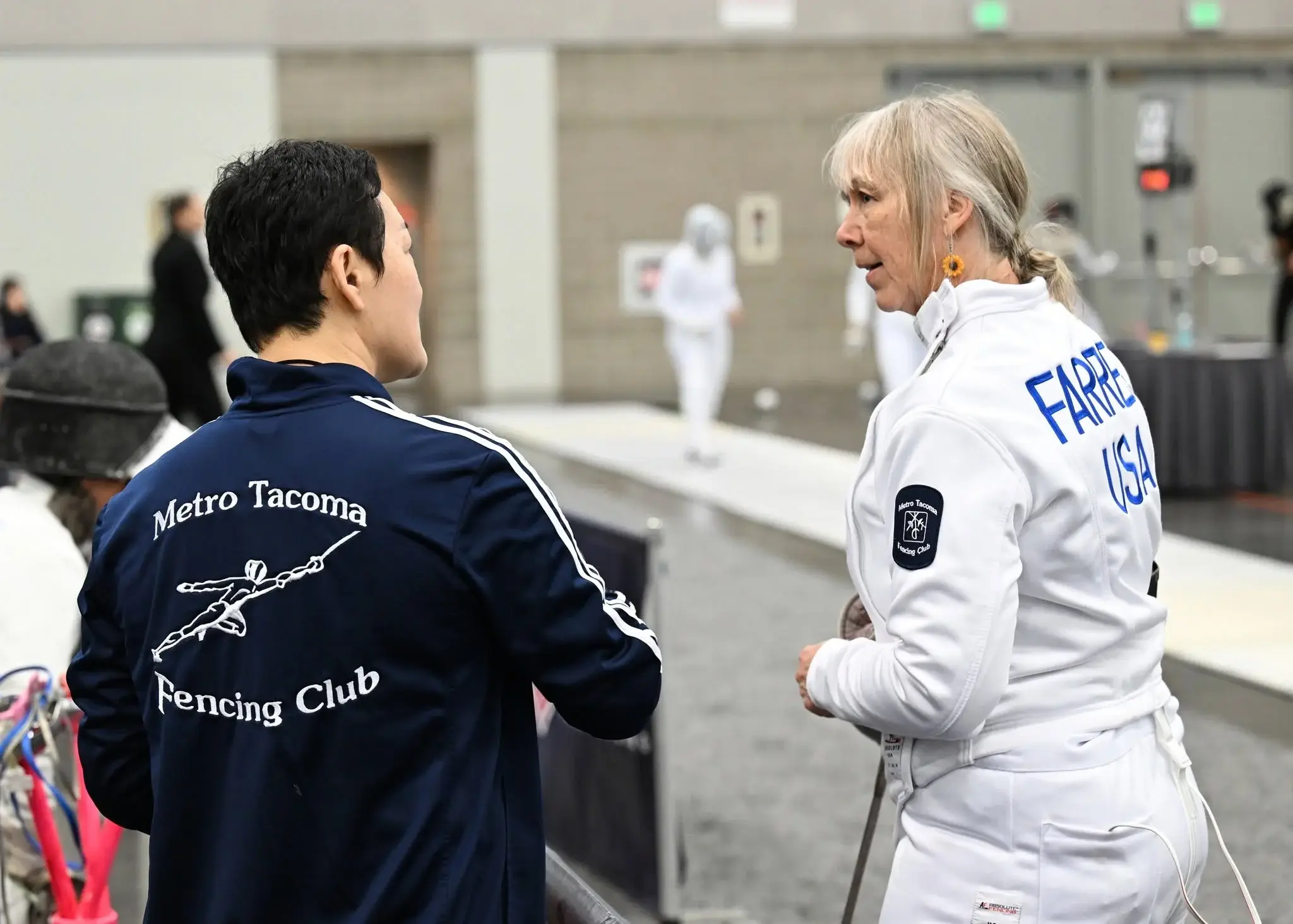 Fencers on the strip during a coaching session