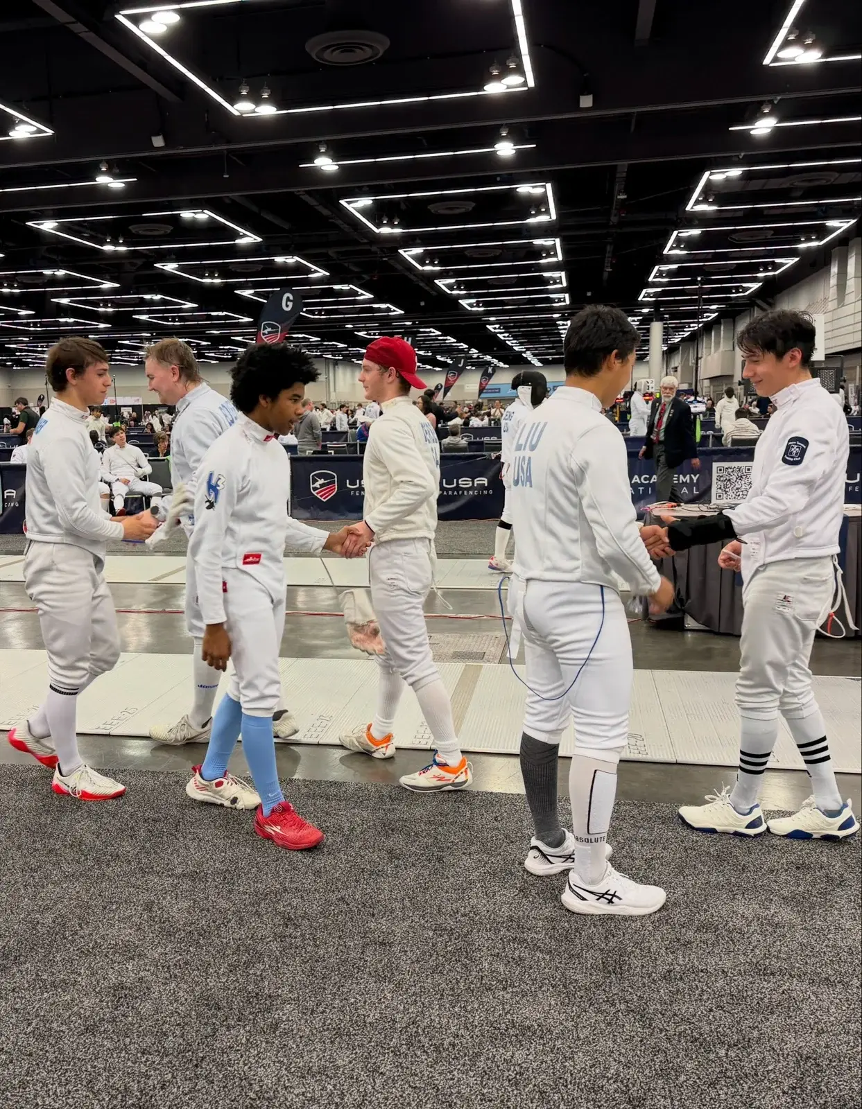 Competitive fencers from Metro Tacoma Fencing Club at a tournament